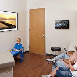 MedSpring Urgent Care - Exam rooms with flat screen TV, couch and Wi-Fi