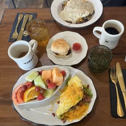 Denver omelet with fruit. Meat lover's breakfast bowl with biscuits and gravy. Two drip coffees.