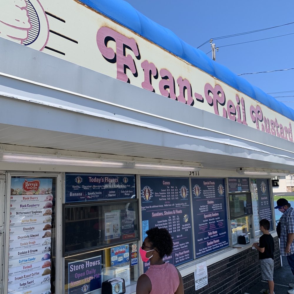 people standing outside of a restaurant
