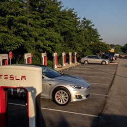 Tesla Supercharger - 4 stalls available with EV Only parking 24/7; 4 stalls allow internal combustion engine vehicles to park between the hours of 8 PM to 8 AM.