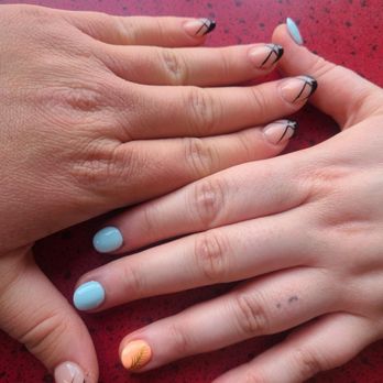 Season Nails - Two hands. One with black ballet slipper french tip nails. The other hand has blue pastel nails with one peach nail. - Nail Salons Near Me - Bloomington, Minnesota