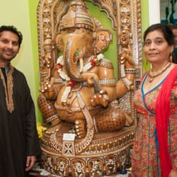 Urban Sadhu Yoga Jersey City - Nelly and Manish next to their gift of Ganesha