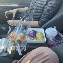 Spanish lattes, dragon fruit refresher, ube and pistachio donuts, coffee bun, and blueberry cream cheese bun