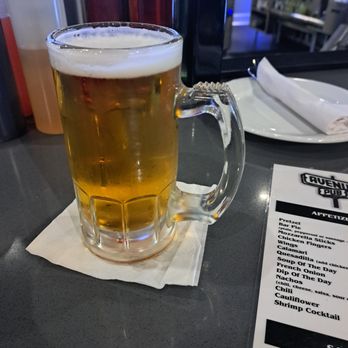 Avenue Pub - a glass of beer on a table - Burgers Near Me - Maplewood, New Jersey