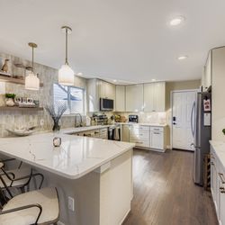 The Harmony Developer - Inviting open-concept living space with elevated flooring and a seamless transition into the kitchen and dining space.