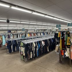 Bargain Thrift Store - Clothing racks across the sales floor. Open 7 days: Mon-Sat 10 AM-8 PM, Sun 10 AM-6 PM.