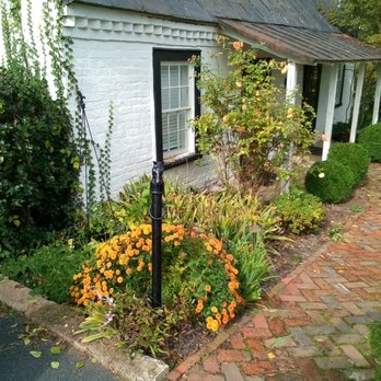 DOC Landscaping - a brick path leading to a white house - Landscaping Near Me DOC Landscaping - a brick path leading to a white house - Landscaping Near Me