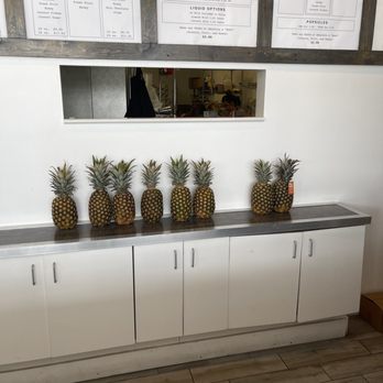 Ivie Juice Bar - a row of pineapples on a counter - Juice Bars & Smoothies Near Me - Orem, Utah