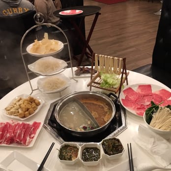 IPOT - Left to right: Lamb, puffed tofu, bean curd, fried bean curd, tripe, udon, biangbiang, Wagyu, spinach, enoki.  Chinese herbal & spicy miso - Hot Pot Near Me - San Francisco, California