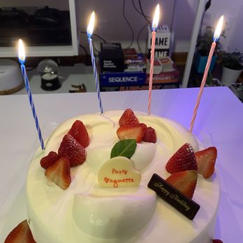 Paris Baguette - A round birthday cake with white frosting, topped with strawberries, candles, and decorative messages for a celebration. - Bakeries Near Me - Chicago, Illinois
