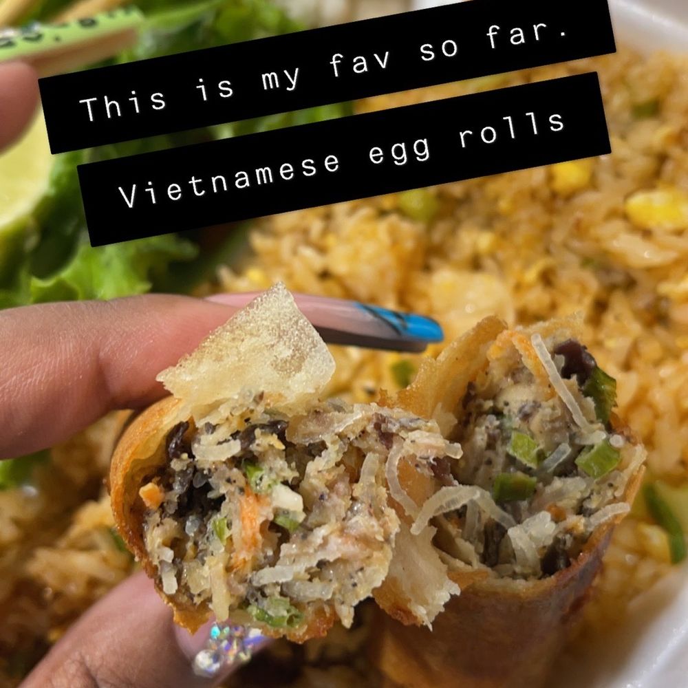 Pho Saigon - a person holding a piece of food - Vietnamese Near Me - Houston, Texas