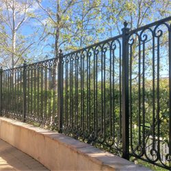 JC Iron & Mfg Co - Custom black metal fence featuring classic scrollwork along the top and bottom rails.