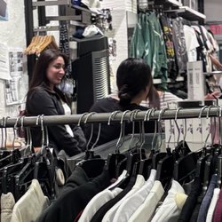 PacSun - All three of them having personal conversations with inappropriate language. "Manager" back towards the camera with the bun.