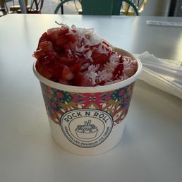 Strawberry ice cream with strawberries, banana, coconut flakes, and strawberry drizzle Strawberry ice cream with strawberries, banana, coconut flakes, and strawberry drizzle