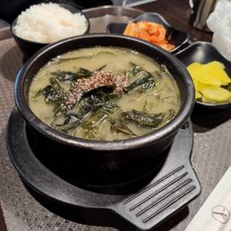 Seaweed soup with a side of rice, fresh kimchi and pickled radish
