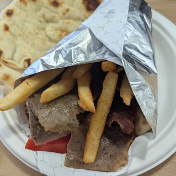 Gyro Gods - Gyro meat with fries and fresh veggies, on a griddled pita. - Greek Near Me - Westland, Michigan Gyro Gods - Gyro meat with fries and fresh veggies, on a griddled pita. - Greek Near Me - Westland, Michigan