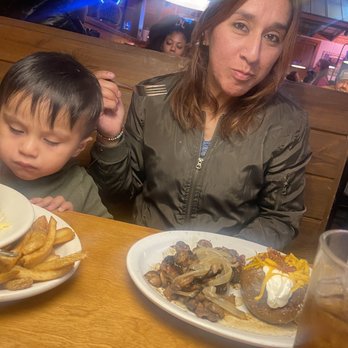 Texas Roadhouse - My wife n son enjoying a sirloin n loaded potato - Steakhouses Near Me - Indianapolis, Indiana Texas Roadhouse - My wife n son enjoying a sirloin n loaded potato - Steakhouses Near Me - Indianapolis, Indiana