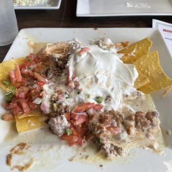 Cinco De Mayo - Kentlands - This is the nachos supreme after a couple chips we're eaten from the edges but you get the picture. - Mexican Near Me - Gaithersburg, Maryland Cinco De Mayo - Kentlands - This is the nachos supreme after a couple chips we're eaten from the edges but you get the picture. - Mexican Near Me - Gaithersburg, Maryland