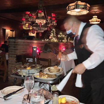Clearman's Steak 'N Stein - Waiter putting the good stuff on the baked potato - Steakhouses Near Me - Pico Rivera, California