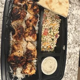 Chicken kabob plate with extra skewer of chicken breast along with garbanzo salad and rice. Chicken kabob plate with extra skewer of chicken breast along with garbanzo salad and rice.
