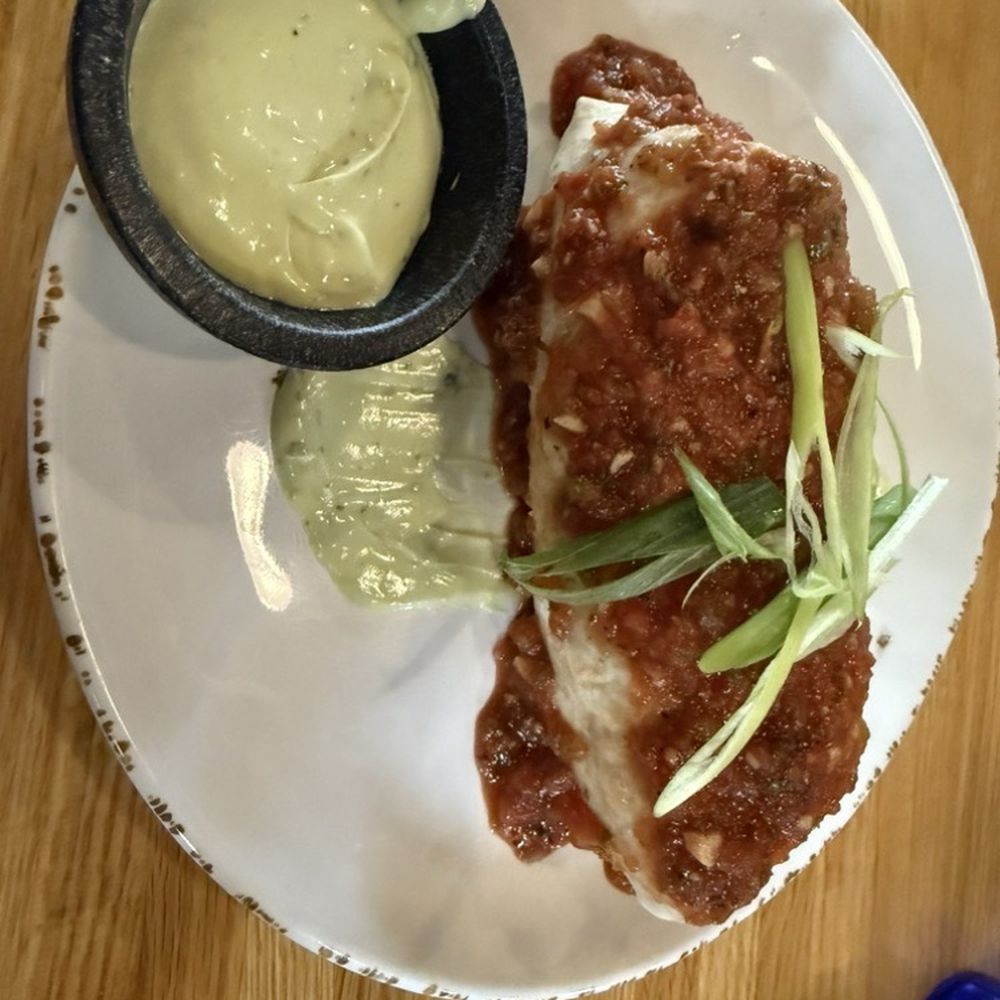 Burrito de Pollo with a side of avocado crema