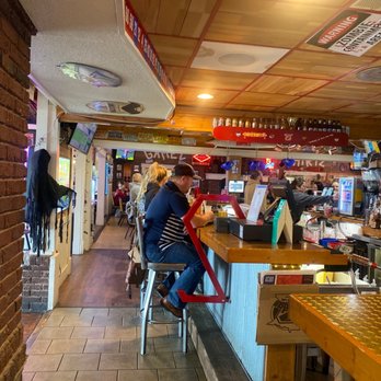 Zorbaz - a woman sitting at a bar - Pizza Near Me - Spicer, Minnesota