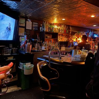 Hotsy Totsy Club - a man sitting at a bar - Lounges Near Me - Albany, California