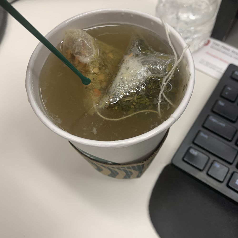 a cup of tea with ice and a straw a cup of tea with ice and a straw