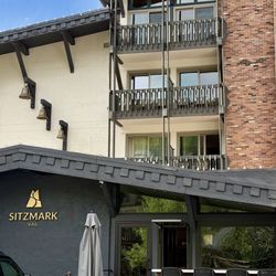 Front of hotel with nice seating area in front.