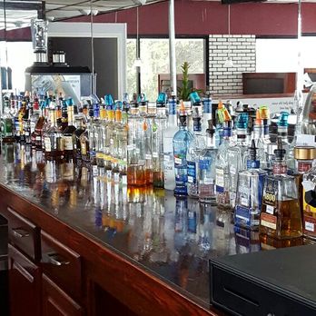 The Lounge - a long bar filled with bottles of alcohol - American Near Me - Burlington, North Carolina The Lounge - a long bar filled with bottles of alcohol - American Near Me - Burlington, North Carolina