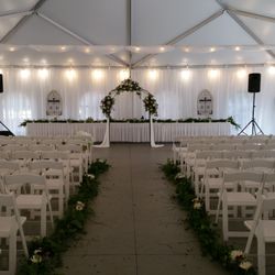 Celebrate Events & Party Rental - Frame tent with White Resin chairs