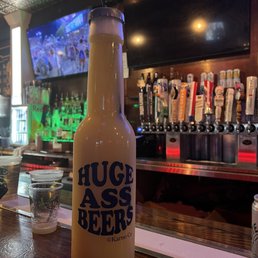 a bottle of beer sitting on a bar a bottle of beer sitting on a bar