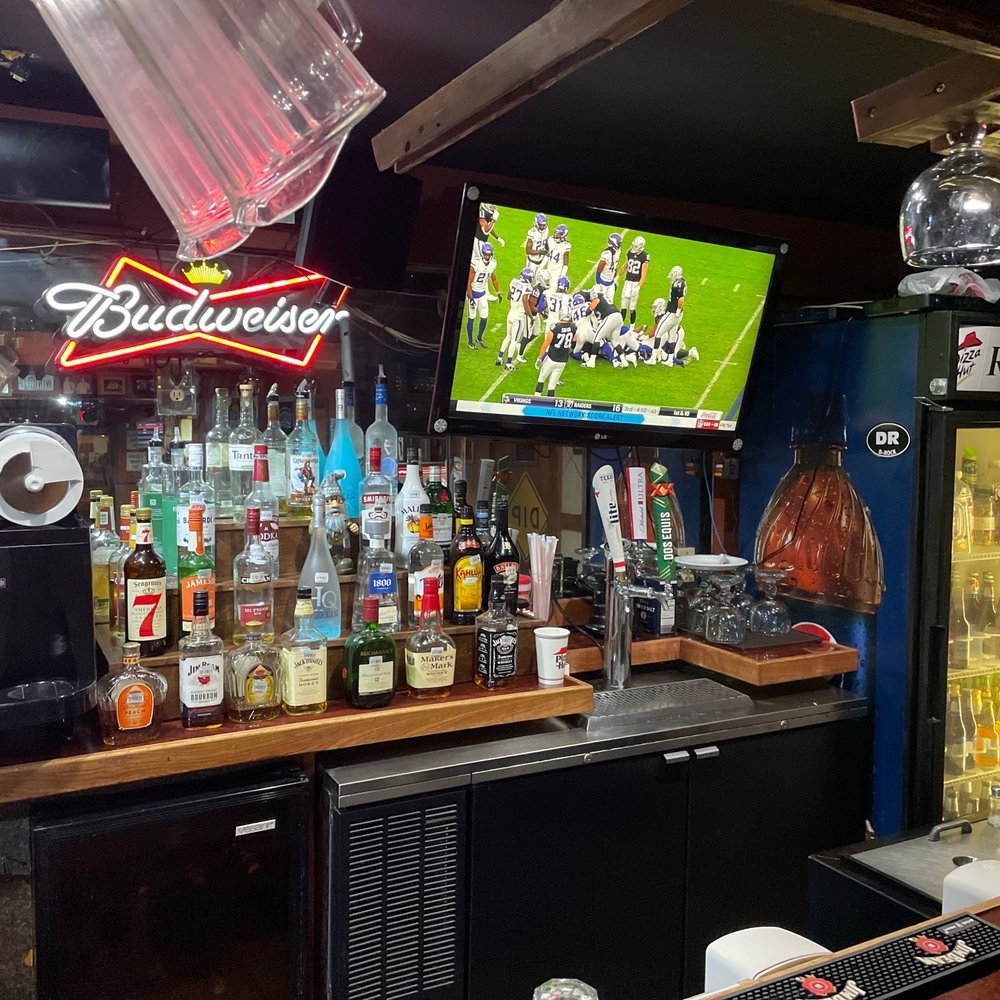 a bar with a television and drinks a bar with a television and drinks