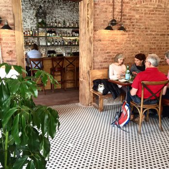 Marlow Bistro - Interior vibe with cool floors, exposed brick, lively plants and a bar in separate part of the restaurant with a white wall wash. - Mediterranean Near Me - New York, New York Marlow Bistro - Interior vibe with cool floors, exposed brick, lively plants and a bar in separate part of the restaurant with a white wall wash. - Mediterranean Near Me - New York, New York