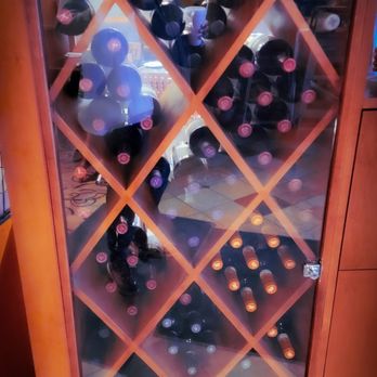 2Booli - a display of wine bottles in a wine rack - Mediterranean Near Me - Farmington Hills, Michigan