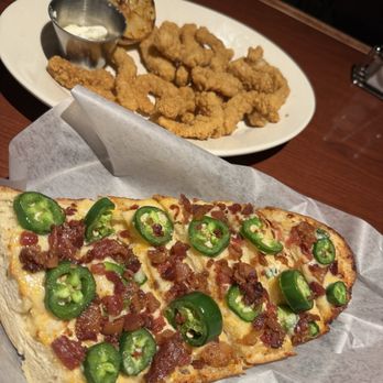 Black Angus Steakhouse - Three Cheese Garlic Bread with bacon and jalapeño and Crispy Fried Calamari for appetizers - Steakhouses Near Me - Puyallup, Washington Black Angus Steakhouse - Three Cheese Garlic Bread with bacon and jalapeño and Crispy Fried Calamari for appetizers - Steakhouses Near Me - Puyallup, Washington