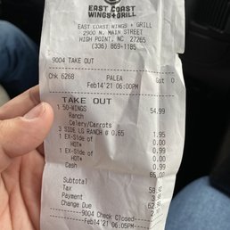 a hand holding a receipt
