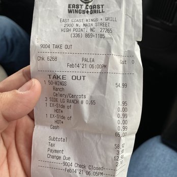 East Coast Wings + Grill - a hand holding a receipt - Chicken Wings Near Me - High Point, North Carolina