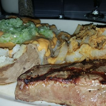 Clearman's Steak 'N Stein - Potato with all the trimmings, onion rings, and steak!! - Steakhouses Near Me - Pico Rivera, California