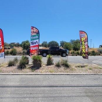 Pizza Pocalypse - a parking lot with flags and a truck - Pizza Near Me - Marble Falls, Texas Pizza Pocalypse - a parking lot with flags and a truck - Pizza Near Me - Marble Falls, Texas
