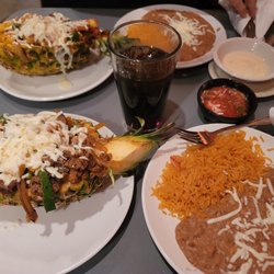 Casa Familia - Chicken, steak, shrimp, peppers, onions, and cheese served in a pineapple bowl; rice and beans