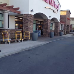 Smart & Final Extra! - Outside, has shopping baskets, carts, and the big carts.
