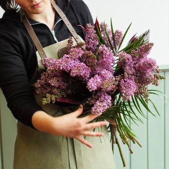 Reids Florists - One of our florists arranging a bouquet of lilac flowers. - Florists Near Me - Belfast, BFS Reids Florists - One of our florists arranging a bouquet of lilac flowers. - Florists Near Me - Belfast, BFS