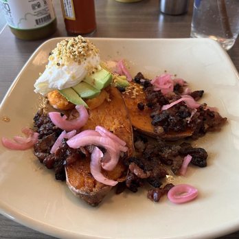 Snooze, an A.M. Eatery - Smashed sweet potato with bacon and a poached egg. - Breakfast & Brunch Near Me - Frisco, Texas