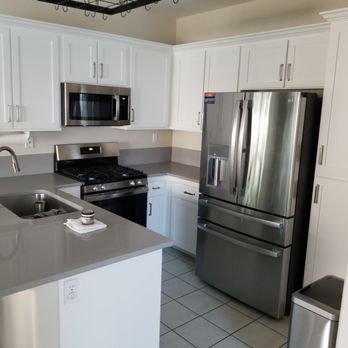 Refined Coatings - Cabinets were previous a tan oak with visible wood grains. New shaker-style doors & handles replaced. Cabinet base refinished & painted. - Refinishing Services Near Me - San Diego, California