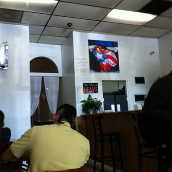 Sabor Latino - a woman sitting at a table in a restaurant - Puerto Rican Near Me - Jacksonville, Florida Sabor Latino - a woman sitting at a table in a restaurant - Puerto Rican Near Me - Jacksonville, Florida