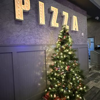 Parma Pizza Bar - a decorated christmas tree in front of a pizza sign - Pizza Near Me - Yorkville, Illinois Parma Pizza Bar - a decorated christmas tree in front of a pizza sign - Pizza Near Me - Yorkville, Illinois