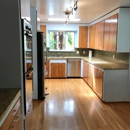 The updated kitchen, which started off a retro lemon yellow. They took off Every. Single. Cabinet. to make it happen.