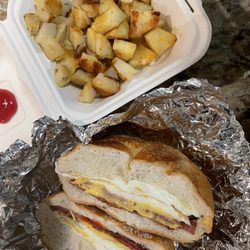 Riverdale Luncheonette - Taylor ham, egg & cheese breakfast sandwich with a side of potatoes.