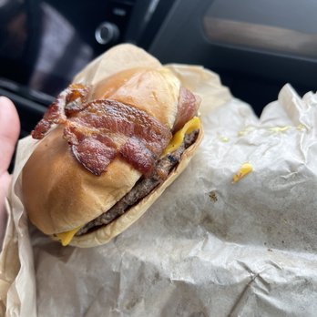 Burgerville - a hand holding a bacon cheeseburger - Burgers Near Me - Woodland, Washington